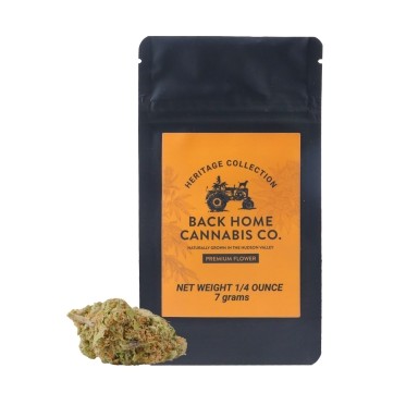 A black resealable pouch labeled "Back Home Cannabis Co. Heritage Collection" with an image of a tractor, next to a small pile of cannabis buds; the package states "Net Weight 1/4 Ounce, 7 grams.