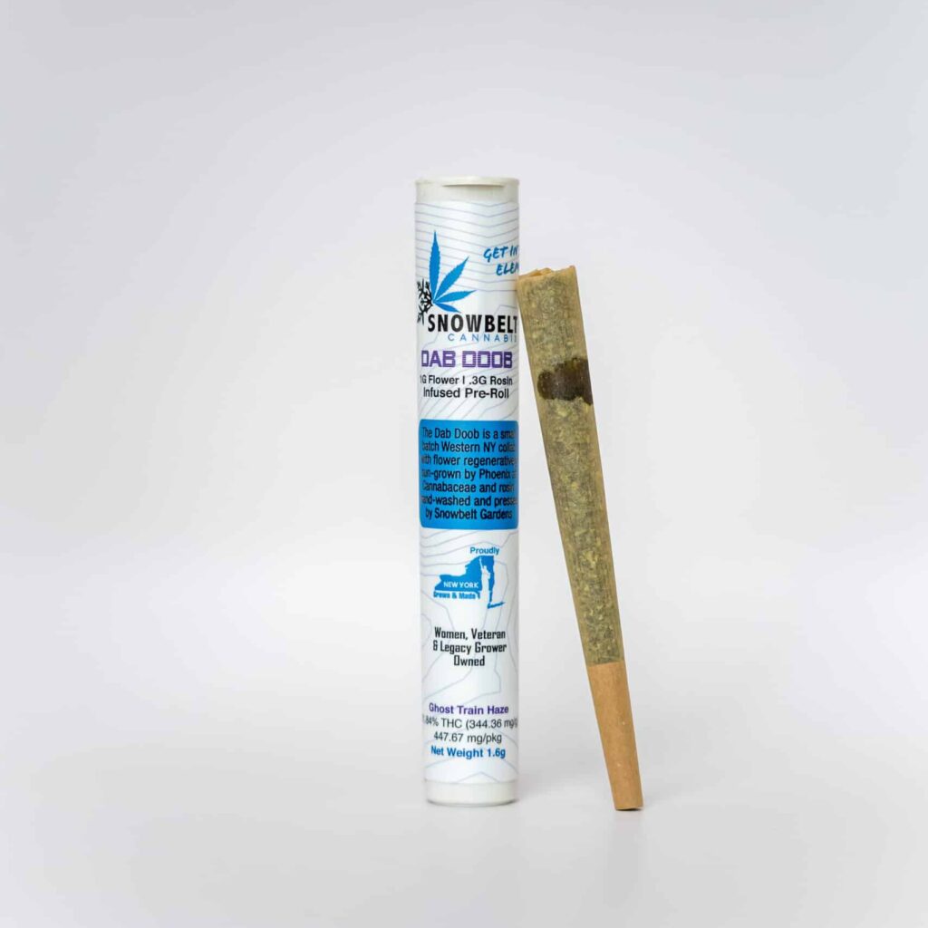 A pre-rolled cannabis joint stands upright next to its white cylindrical packaging labeled "Snowbelt" with blue and black text and graphics, against a plain white background.