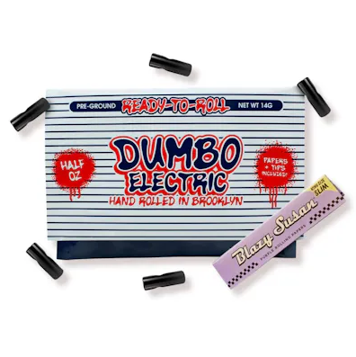 A Dumbo Electric pre-ground cannabis bag labeled "Ready-to-Roll," "Hand Rolled in Brooklyn," and "Half Oz" sits surrounded by black tip pieces, next to a Blazy Susan rolling paper pack.