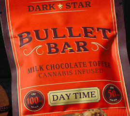 A red package labeled "DARK STAR BULLET BAR" with "Milk Chocolate Toffee Cannabis Infused" printed below. The package also notes "THC 100 mg" and "CBD 50 mg," and "Day Time" is highlighted at the bottom.