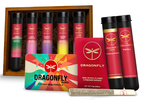 A collection of Dragonfly-branded cannabis products including pre-roll tubes, a colorful tin, red packaging, and a single pre-rolled joint, all featuring a dragonfly logo.