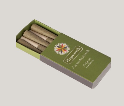 A green and brown box labeled "Hepworth" containing five cannabis pre-rolls, each partially visible, with a colorful geometric design on the packaging.