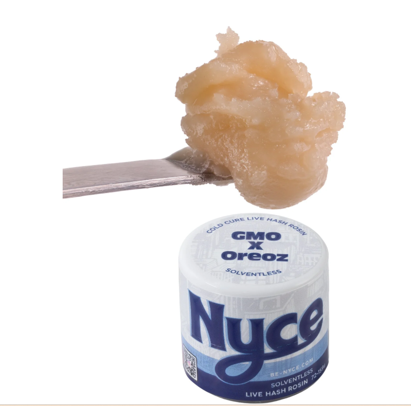 A metal tool holds a glob of creamy, tan hash rosin above a white container labeled "Nyce GMO x Oreoz Live Hash Rosin" with blue text and a frosty design.