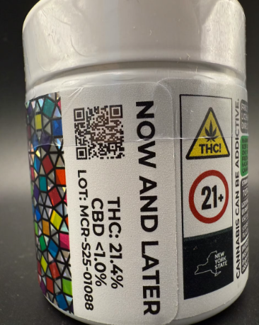 A white cannabis container labeled "NOW AND LATER" displays THC 21.4%, CBD <1.0%, a QR code, and warnings for THC, age 21+, and New York State compliance, with a colorful geometric pattern on the side.