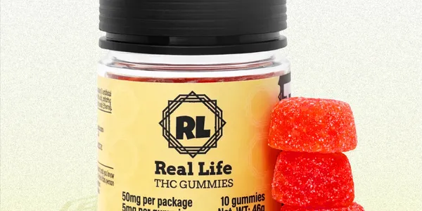 A jar labeled "Real Life THC Gummies" with a yellow label is shown next to a small stack of red, sugar-coated gummy candies. The jar states it contains 50mg THC per package, with 10 gummies total.