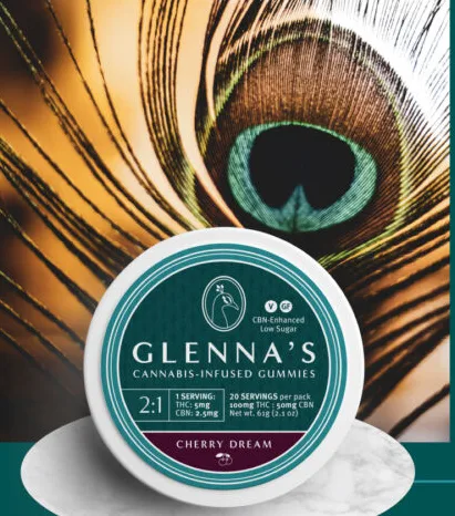 A container of Glenna's cannabis gummies sits in front of a vibrant peacock feather background.