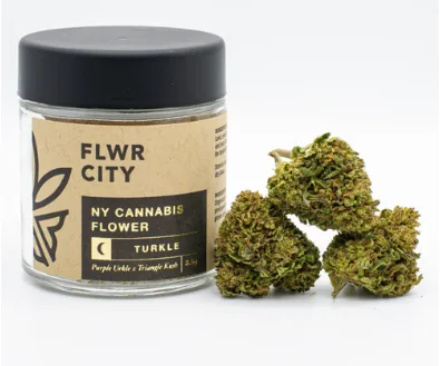 A jar labeled “FLWR CITY NY Cannabis Flower” with cannabis buds beside it on a white background.