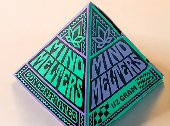 A colorful pyramid box displays “Mind Melters Concentrates” and “1/2 gram” with bold leaf graphics.