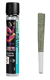 A pre-rolled joint sits beside a labeled glass tube with colorful artwork and cannabis branding visible.