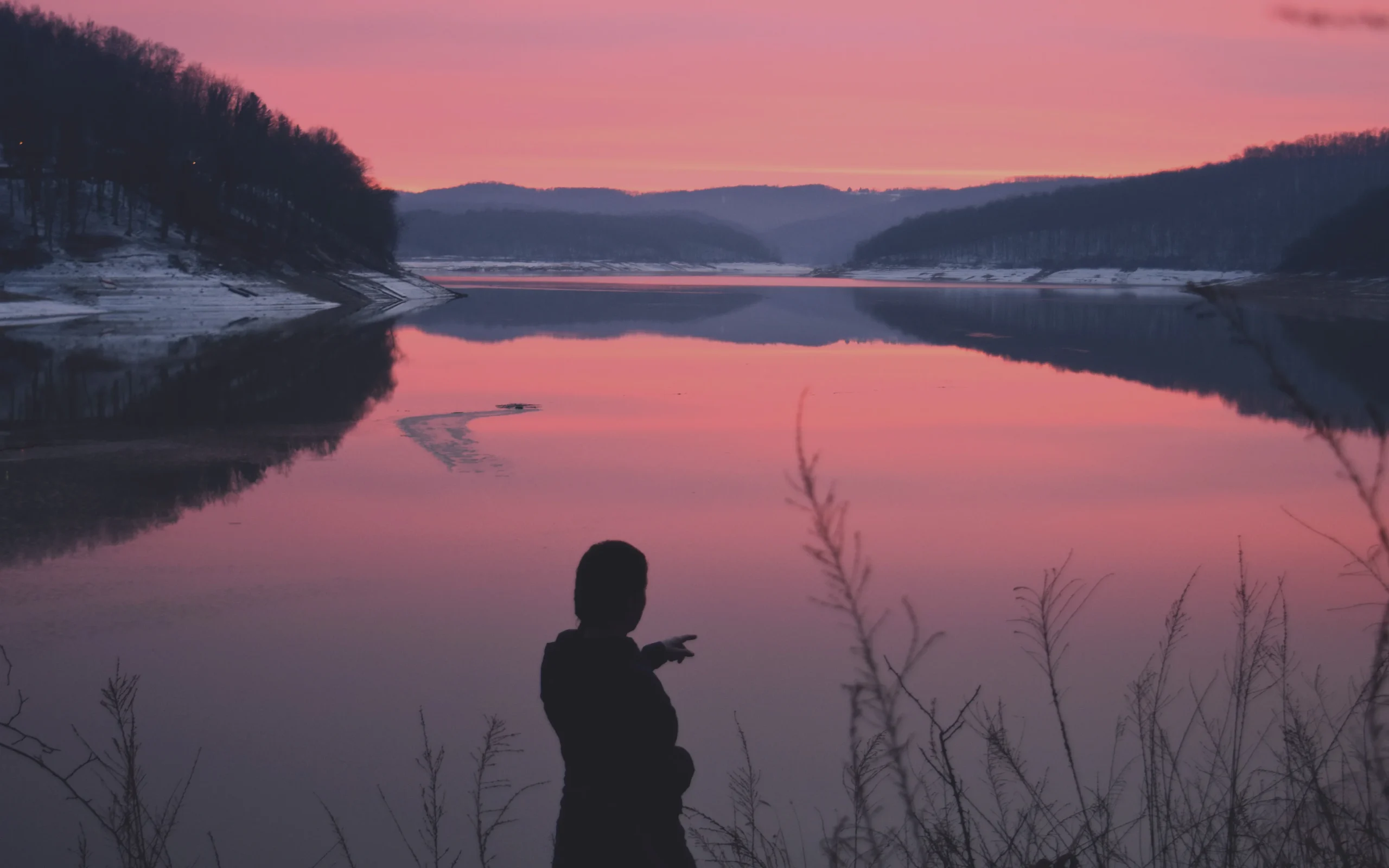 Person at a calm lake at dusk, Wyld lifestyle photo